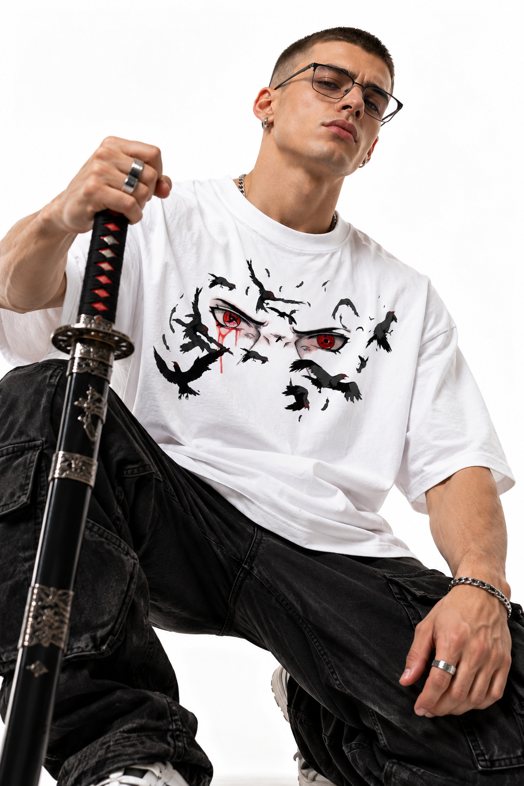 Itachi Crow Oversized Tee 5 Model wearing white Itachi Crow Oversized Tee in a seated pose holding a sheathed sword